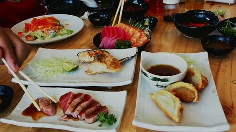 Group of people using chopsticks for eating japanese food. Stock Footage 109039367