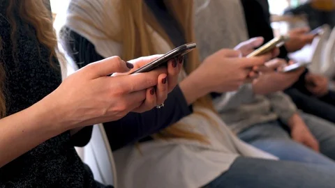 Group of people using mobile phones in a cafe instead of communicating with each Stock Footage
