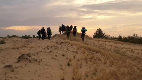 Group of people walking on the desert Stock Footage 129108102
