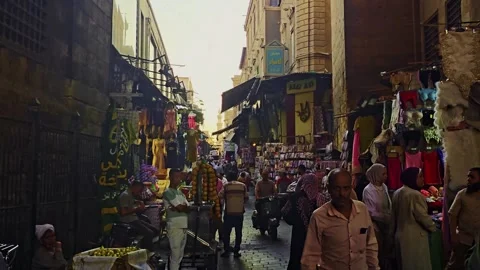 A group of people walking down a narrow street Stock Footage 292190084