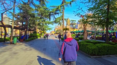A group of people walking down a sidewalk Stock Footage 273009837