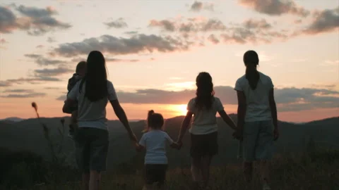 Group people walking with hands up on background beautiful mountains and sunset Stock Footage 282006113