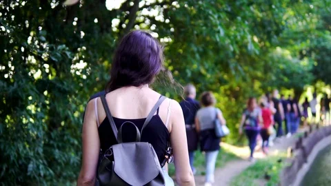 Group of People walking next to a river and forest Stock Footage 113299434