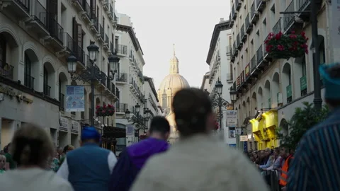 Group of people walking in a procession to the historical monument in Zaragoza Stock Footage 221436253