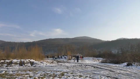 Group of people walking in the snow Stock Footage 149016701