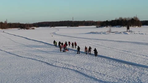Group of people walking in snowy path on lake ice, Lappeenranta Finland Stock-Footage 169345036