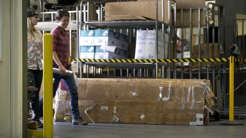 Group of people walking through warehouse carrying packed lunch Stock Footage 88028223