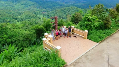 A Group of People Waving at a Drone as It Flies over Them Stock Footage 157482916