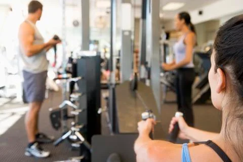 Group of people weight training at gym Stock Photos