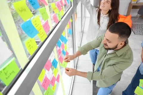 Group of people working with business plan at Kanban board on window in offic Stock Photos