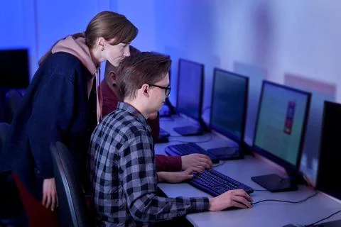 A group of people working as programmers, discussing their work, in the office. Stock-Fotos