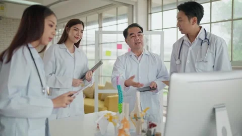 Group of physician talking about human skeleton anatomy in computer for treating Stock Footage 274637924