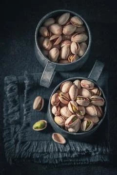 Group of pistachios on dark table. Source of minerals. Stock Photos