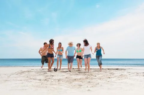 Group playing with ball on beach Stock Photos