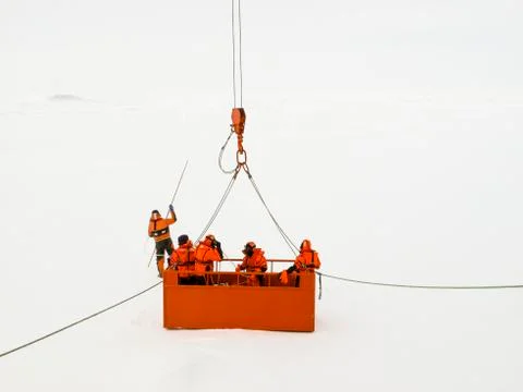 Group of polar scientists checking an ice floe Stock Photos