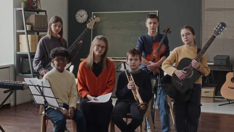 Group Portrait of Five School Kids and Young Teacher in Music Class Stock Footage 280260454