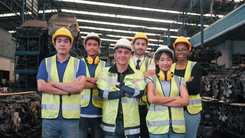 Group portrait of multiethnic industrial workers team looking camera in factory. Stock Footage 156384819