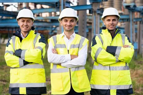 Group portrait of multiethnic industrial workers team consist of technicians Stock Photos
