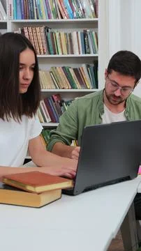 Group of positive students using laptop preparing for high school exams sit.. Stock Photos