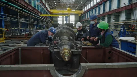 Group of power engineers are designing a new type of steam turbine at Factory Stock Footage 154383555