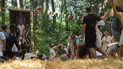 Group practices contact improvisation in expressive movements on straw in forest Stock Footage 323653445