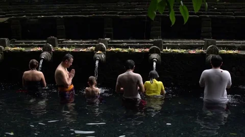 Group praying at holy spring water temple in Bali, Indonesia Stock-Footage 74398784
