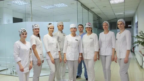 A group of professional doctors in uniform in the lobby of a modern clinic. Stock-Footage 133305255