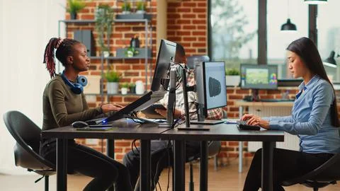 Group of professional editors working with artificial intelligence Stock Photos