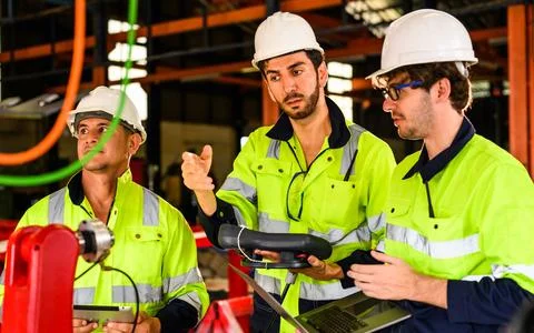 Group of professional mechanical engineer team checking and repairing engine Foto stock