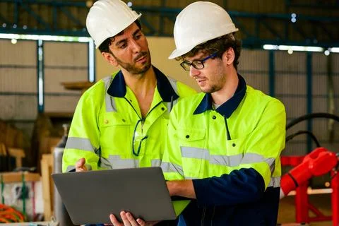 Group of professional mechanical engineer team checking and repairing engine Stock Photos