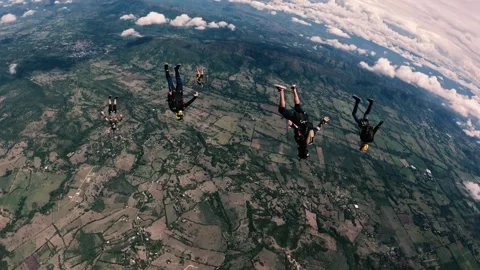 A group of professional sky divers gaining speed in free fall Stock Footage 259027991