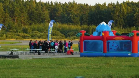 Group of professional skydivers in jumpsuits discussing after a successful Stock Footage 159779760