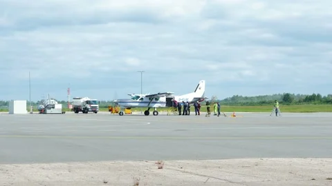 Group of professional skydivers moving into the white single wing aircraft Stock Footage 159779837