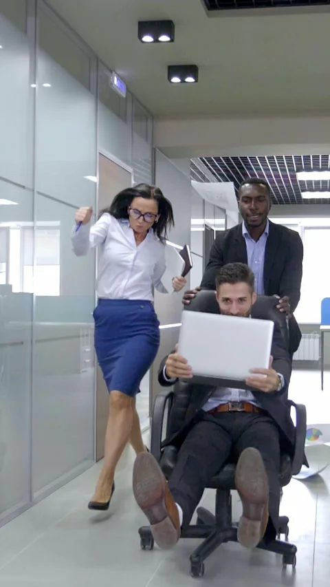 Group of professionals in office environment engaged in dynamic teamwork and Stock Footage 313257395