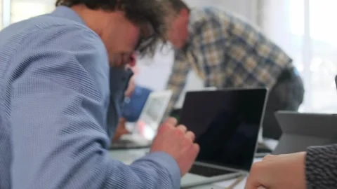 Group of professionals working together on project schedule in bright meeting Stock Footage 319980128