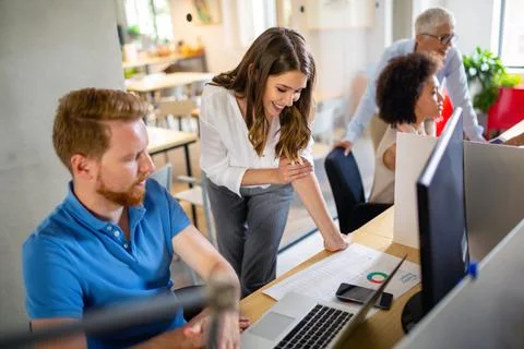 Group of programmer working in a software developing company office Stock Photos