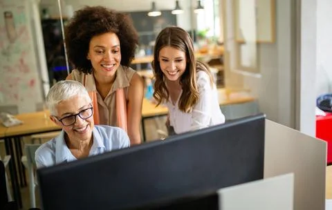 Group of programmer working in a software developing company office Stock Photos