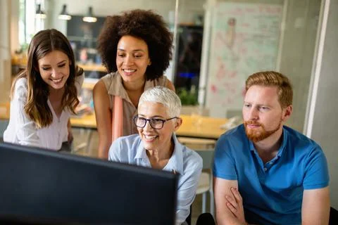 Group of programmer working in a software developing company office Stock Photos