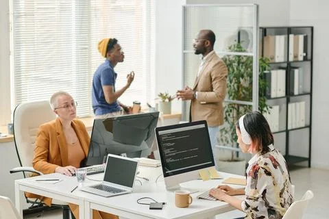 Group of programmers cooperating at office 스톡 사진