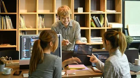 Group of programmers or software developers brainstorming and working on a new Stock Photos