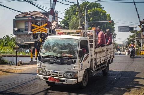 Group of project workers riding in the back of an Isuzu truck belonging to .. Stock Photos