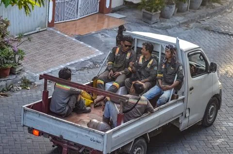 A group of project workers riding in a pick-up truck when they got home fro.. Stock Photos
