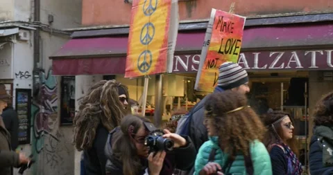 A group of protesters with "Make Love not War" peace signs at Venice Carnival. Stock Footage 151963238