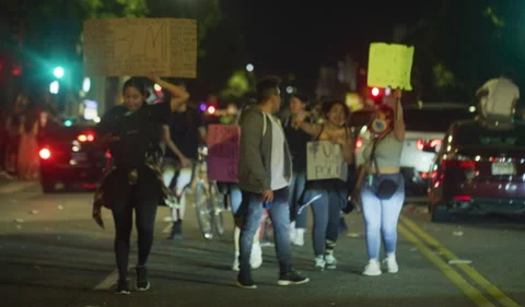 Group of protestors walking down street  hollywood night Stock Footage 143405510