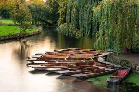 Group of punts docked on the side of rive Cam, Cambridge, UK Stock Photos