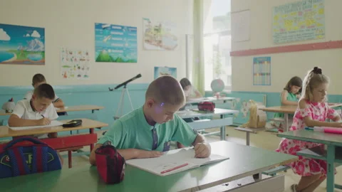 A group of pupils doing a task in a classroom - elementary school concept. Stock Footage 137549033