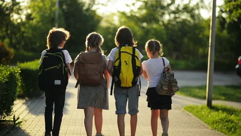 Group of Pupils with School Backpacks Are Going Back to School. They Are Having Stock Footage 89933082