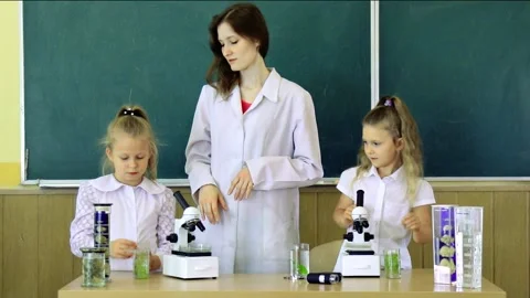 Group Of Pupils With Teacher Using Microscopes In Science Class. Back to scho Stock Footage 164816607