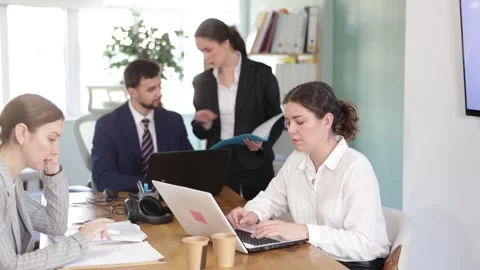Group of qualified employees work in the interior of a modern office. Small firm Stock-Footage 344857714