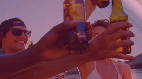 Group raising beer bottles sunset beach, person lifting bottle causing sun rays, Stock Footage 333859731